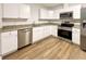 Modern kitchen featuring white cabinets and stainless steel appliances at 21389 Sw 102Nd Street Rd, Dunnellon, FL 34431
