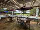 Outdoor patio with tables, umbrellas, and pergola at 21389 Sw 102Nd Street Rd, Dunnellon, FL 34431