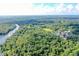 Aerial view of lush landscape, river, and recreational facilities at 21389 Sw 102Nd Street Rd, Dunnellon, FL 34431