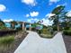 Community clubhouse entrance with landscaped walkway at 21389 Sw 102Nd Street Rd, Dunnellon, FL 34431