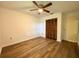 Spacious bedroom with wood-look floors, ceiling fan and double door closet at 21389 Sw 102Nd Street Rd, Dunnellon, FL 34431