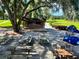 Outdoor patio with tables, umbrellas, and stage area at 21389 Sw 102Nd Street Rd, Dunnellon, FL 34431