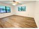 Bright bedroom with wood-look floors and dual windows at 21389 Sw 102Nd Street Rd, Dunnellon, FL 34431
