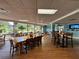 Indoor restaurant with wooden tables and large windows at 21389 Sw 102Nd Street Rd, Dunnellon, FL 34431