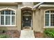 Inviting front entrance with a dark-colored door and decorative accents at 9680 Ne 25Th Ct, Anthony, FL 32617
