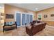 Gathering room with leather sofas, a tiled floor and access to backyard at 9680 Ne 25Th Ct, Anthony, FL 32617