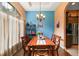 Dining room with a wooden table, blue accent wall, and large window at 9680 Ne 25Th Ct, Anthony, FL 32617
