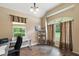 Home office with desk, chair, and large windows at 9680 Ne 25Th Ct, Anthony, FL 32617