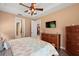 Bedroom with ceiling fan, dresser and access to bathroom and kitchen at 9680 Ne 25Th Ct, Anthony, FL 32617