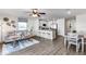 Open living room and kitchen with wood-look floors and a cozy sitting area at 6595 Sw 81St Loop, Ocala, FL 34476