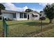 House exterior and fenced backyard with green grass at 8750 Sw 116Th Place Rd, Ocala, FL 34481