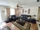 Living room with dark leather furniture and wood floors at 8750 Sw 116Th Place Rd, Ocala, FL 34481