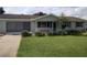 Ranch-style home with carport, landscaping and lawn at 8750 Sw 116Th Place Rd, Ocala, FL 34481