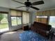 Sunroom with seating, large windows and access to backyard at 8750 Sw 116Th Place Rd, Ocala, FL 34481