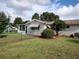 House exterior showcasing a back patio and green lawn at 8750 Sw 116Th Place Rd, Ocala, FL 34481