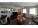 Living room with TV, wood floors, and access to kitchen at 8750 Sw 116Th Place Rd, Ocala, FL 34481