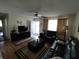 Living room with dark leather furniture and wood floors at 8750 Sw 116Th Place Rd, Ocala, FL 34481