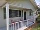 Covered porch with red chairs and a small table at 8750 Sw 116Th Place Rd, Ocala, FL 34481