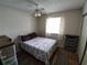 Bright bedroom with double bed, window, and ceiling fan at 8750 Sw 116Th Place Rd, Ocala, FL 34481
