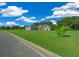 Gray house with green lawn and blue sky, viewed from street at 1934 Nw 79Th Loop, Ocala, FL 34475