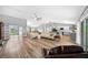 Open concept living room with vaulted ceilings and L-shaped sectional sofa at 1934 Nw 79Th Loop, Ocala, FL 34475