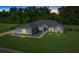 Gray house with red door and landscaped yard at night at 1934 Nw 79Th Loop, Ocala, FL 34475