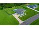 An aerial view of a house with a driveway and green lawn at 1934 Nw 79Th Loop, Ocala, FL 34475
