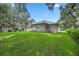 Backyard with lush grass and oak trees at 11196 Ne 227Th Place Rd, Fort Mc Coy, FL 32134