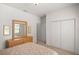 Bright bedroom with mirror, dresser, and double doors leading to the closet at 11196 Ne 227Th Place Rd, Fort Mc Coy, FL 32134