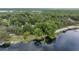 Aerial view of waterfront property with lush trees and boat slips at 11196 Ne 227Th Place Rd, Fort Mc Coy, FL 32134