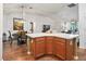 Kitchen island with seating space and hardwood floors at 3812 Nottingham Loop, The Villages, FL 32163