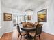 Elegant dining room with chandelier and hardwood floors at 3812 Nottingham Loop, The Villages, FL 32163