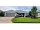 Single story home with attached garage and well maintained landscaping at 3812 Nottingham Loop, The Villages, FL 32163