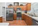 Modern kitchen with stainless steel appliances and wood cabinetry at 3812 Nottingham Loop, The Villages, FL 32163