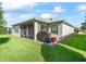 Private backyard with screened patio and grill at 3812 Nottingham Loop, The Villages, FL 32163