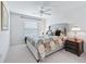 Bedroom with light grey upholstered bed and window seat at 3812 Nottingham Loop, The Villages, FL 32163