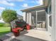 Relaxing backyard patio with grill and seating area at 3812 Nottingham Loop, The Villages, FL 32163