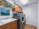 Functional laundry room with washer and dryer at 3812 Nottingham Loop, The Villages, FL 32163