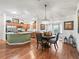 Open concept kitchen and dining area with island and hardwood floors at 3812 Nottingham Loop, The Villages, FL 32163