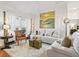 Bright living room featuring a comfy sofa and large artwork at 3812 Nottingham Loop, The Villages, FL 32163