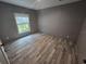 Bright bedroom with wood-look floors and a large window at 3174 Sw 189Th Ave, Dunnellon, FL 34432