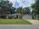 Single-story house with a two-car garage and well-manicured lawn at 5650 Se 34Th St, Ocala, FL 34480