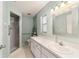 Bathroom with vanity, toilet, shower, and a large mirror at 9692 Sw 95Th Ct # D, Ocala, FL 34481