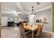 Charming dining area with wood table and chairs, near the living room at 8635 Sw 95Th St # E, Ocala, FL 34481