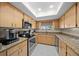 Efficient kitchen with granite countertops and stainless steel appliances at 10820 Sw 87Th Ter, Ocala, FL 34481