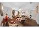 Living room with hardwood floors, comfy seating, and large windows at 10820 Sw 87Th Ter, Ocala, FL 34481