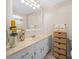Bathroom features a vanity with a large mirror and a neutral color scheme at 10820 Sw 87Th Ter, Ocala, FL 34481
