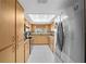 Galley style kitchen with granite countertops and stainless steel appliances at 10820 Sw 87Th Ter, Ocala, FL 34481