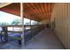 Covered barn stalls with concrete flooring and rural views at 2051 Se 155Th St, Summerfield, FL 34491