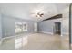 Open living room with tile floors and a ceiling fan at 6760 Cherry Rd, Ocala, FL 34472